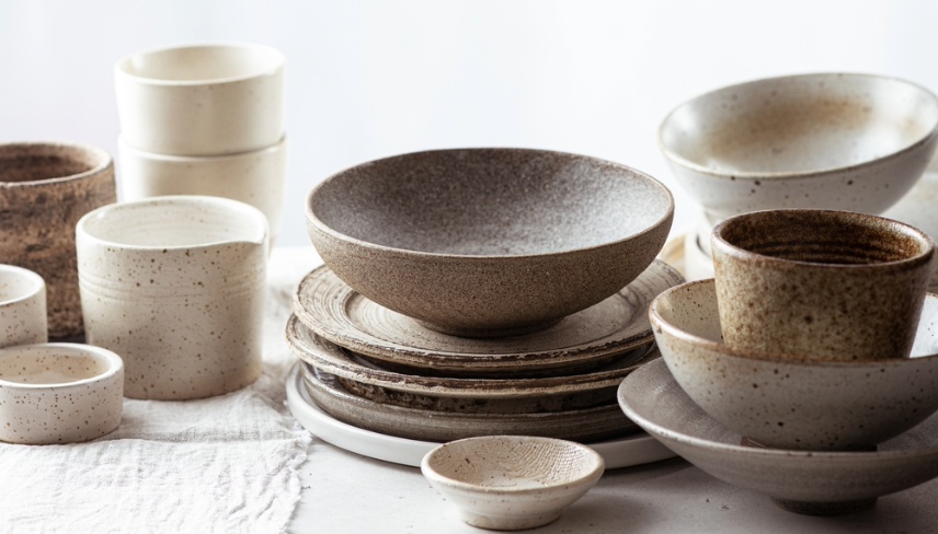 handmade ceramic tableware, empty craft ceramic plates, bowls and cups on light background 