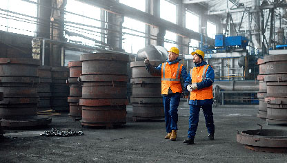 Two inspectors walking through industrial facility
